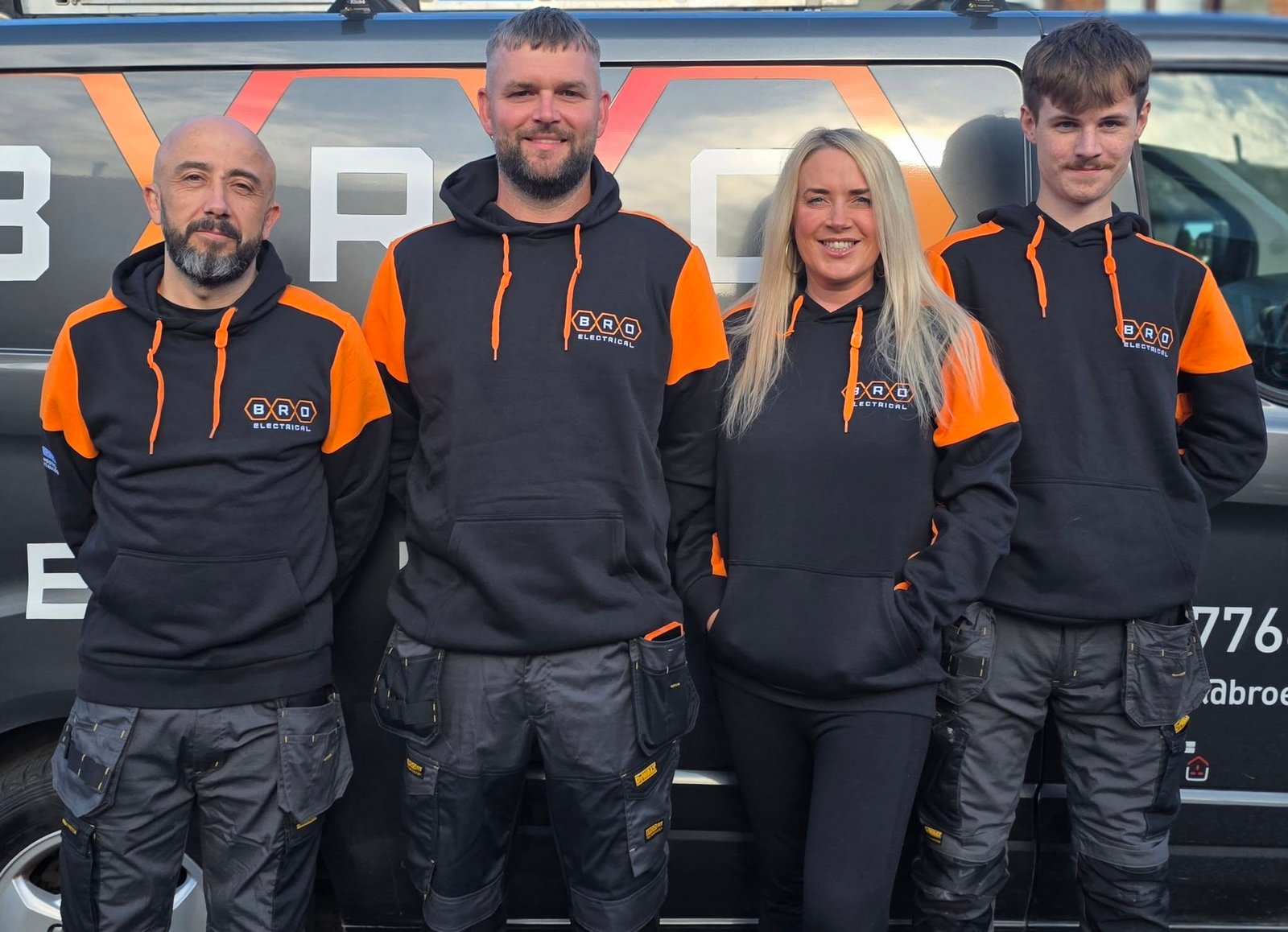 The BRO Electrical team in branded workwear in front of the BRO van, Leeds