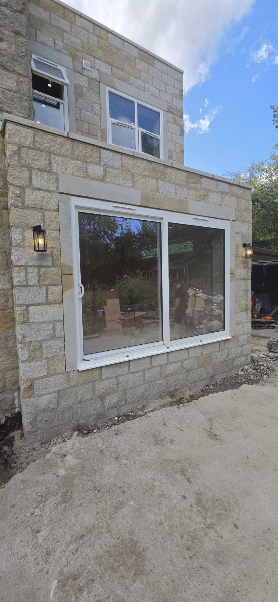 The same extension finished, with stone cladding and a new window and patio door installed