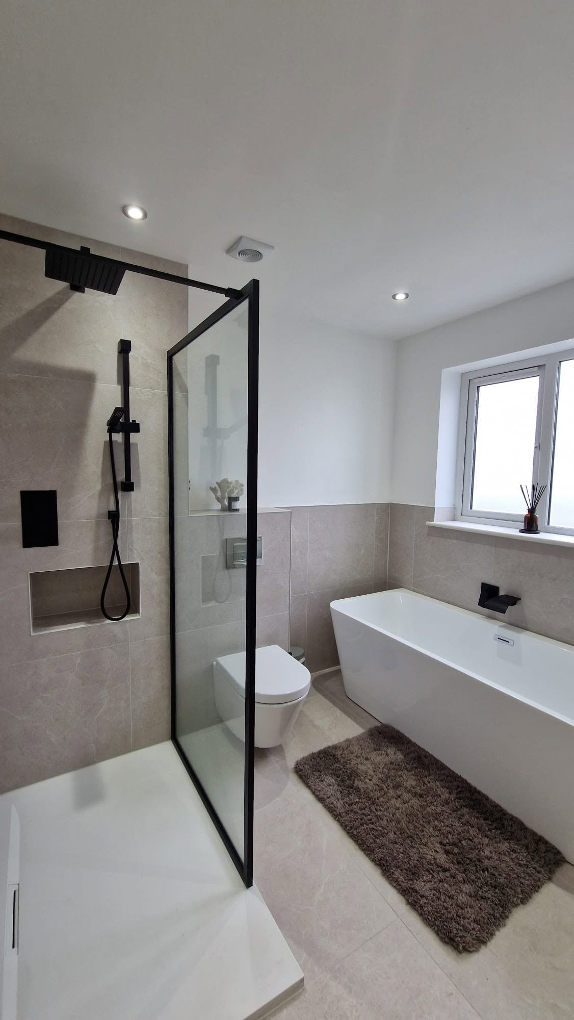 Modern bathroom electrical installation with downlights and extractor fan, Boston Spa bungalow conversion.
