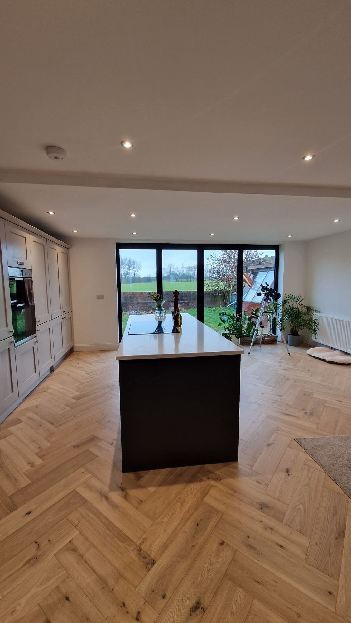 Open-plan kitchen with downlights and hardwired smoke alarm, Boston Spa bungalow conversion.