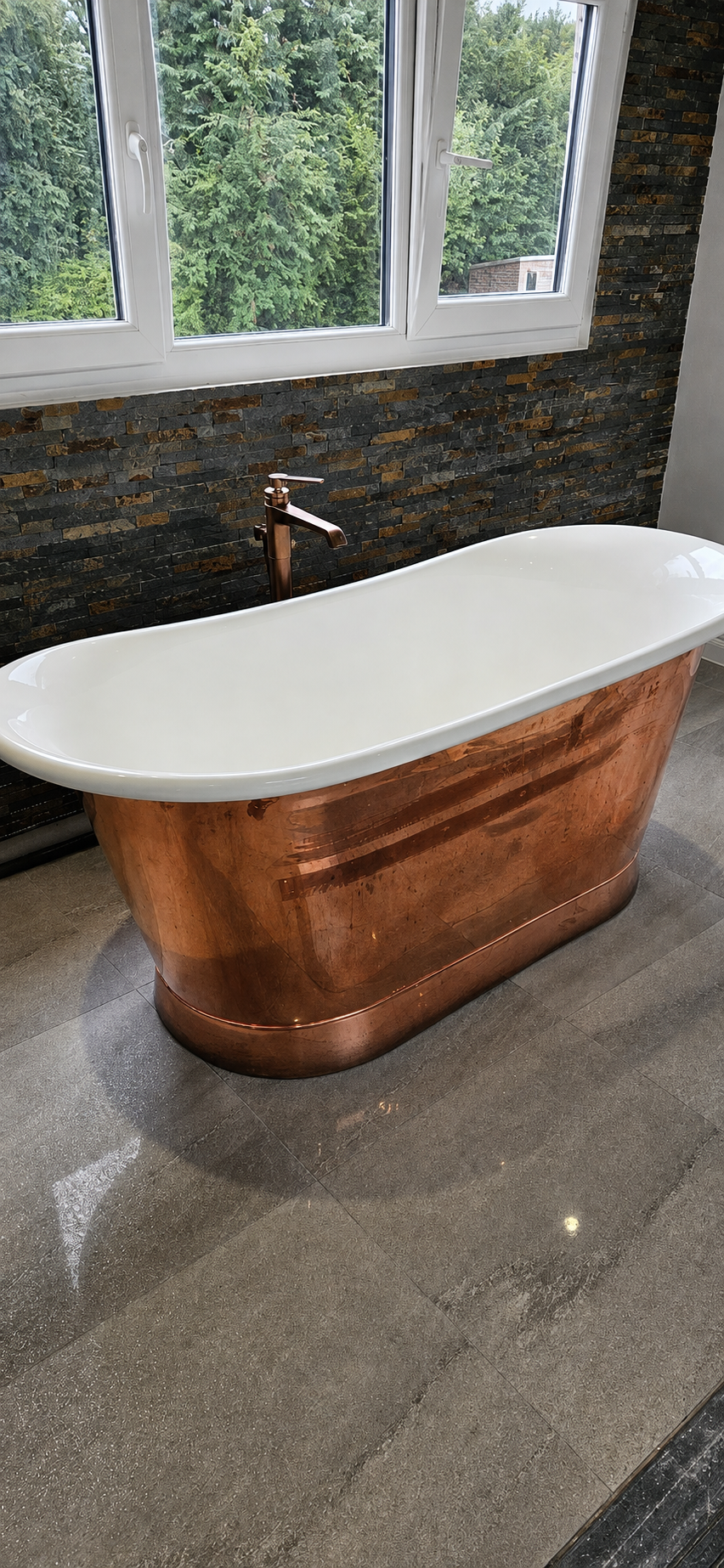 Copper freestanding bath and copper tap installed as part of a loft conversion bathroom in Leeds.