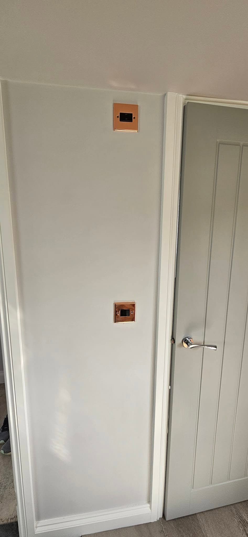 Copper-finish electrical accessories on the landing of a loft conversion in Leeds.