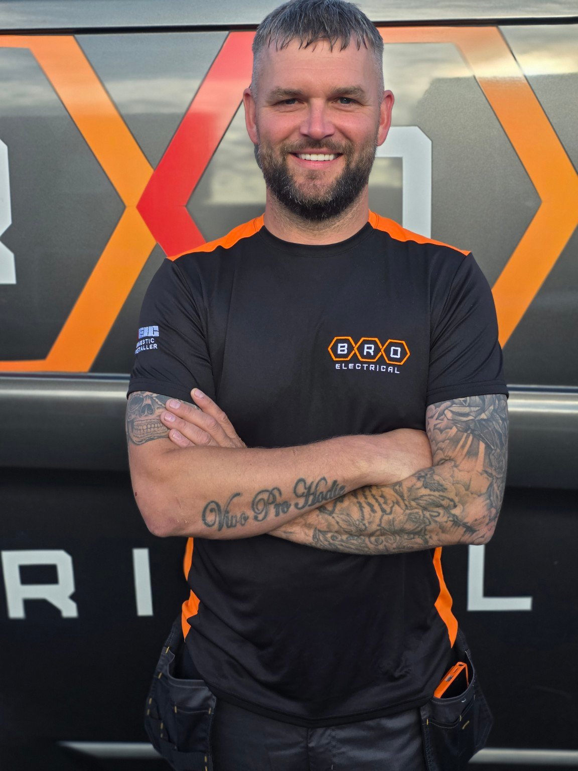Tom O'Brien, BRO Electrical's Qualified Supervisor, standing in front of the BRO Electrical van, Leeds