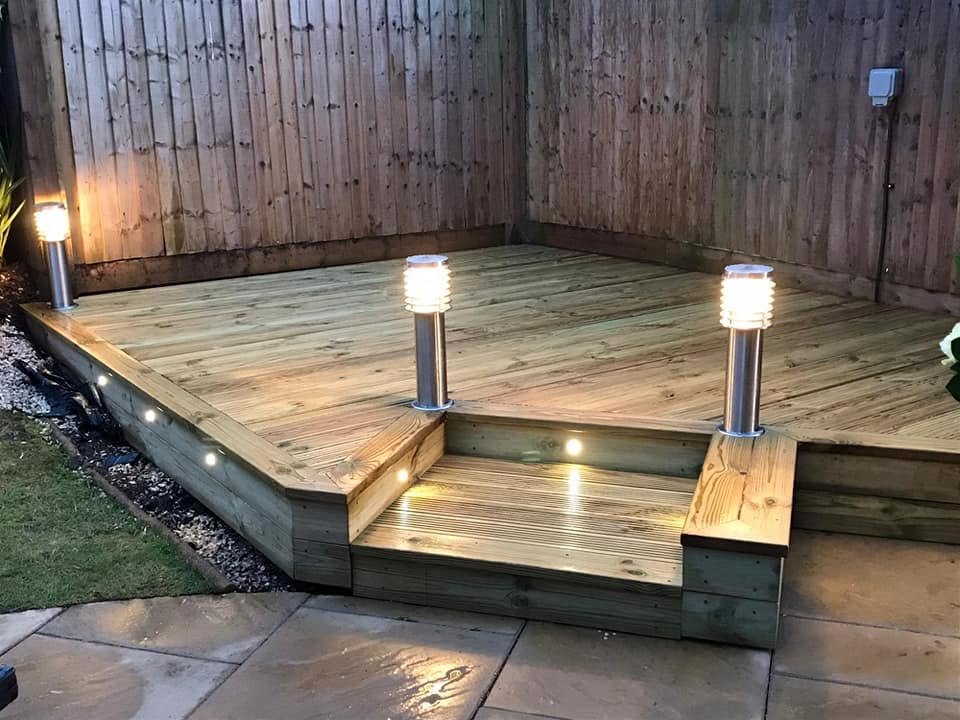 Raised timber decking with integrated bollard lighting and step lighting built into the structure, Leeds