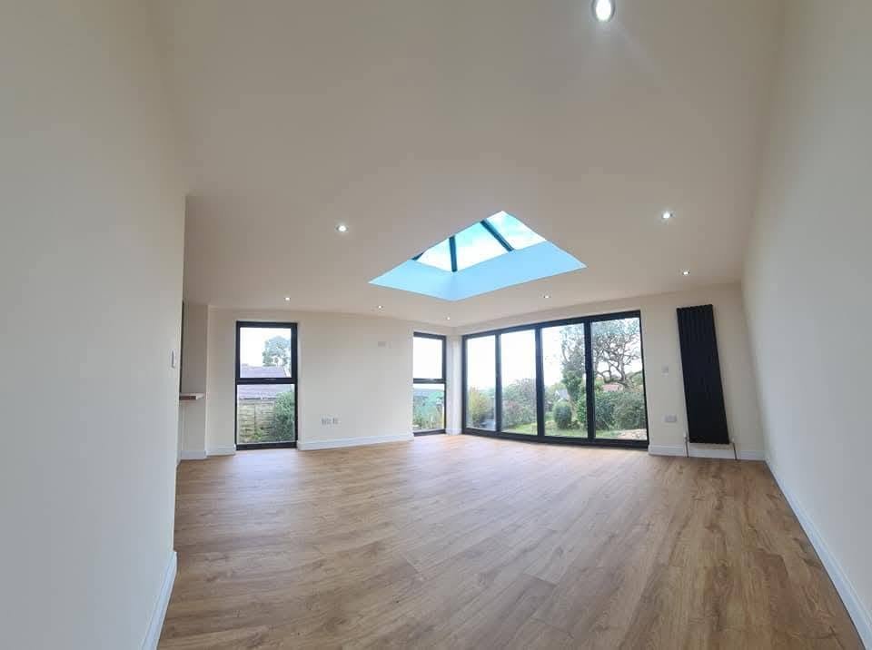 Completed house extension with a large roof lantern, bifold doors and recessed downlights, Leeds